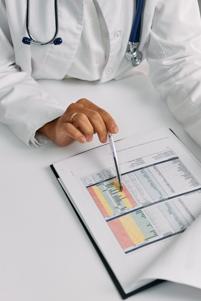 A clinician reviewing charts and healthcare data